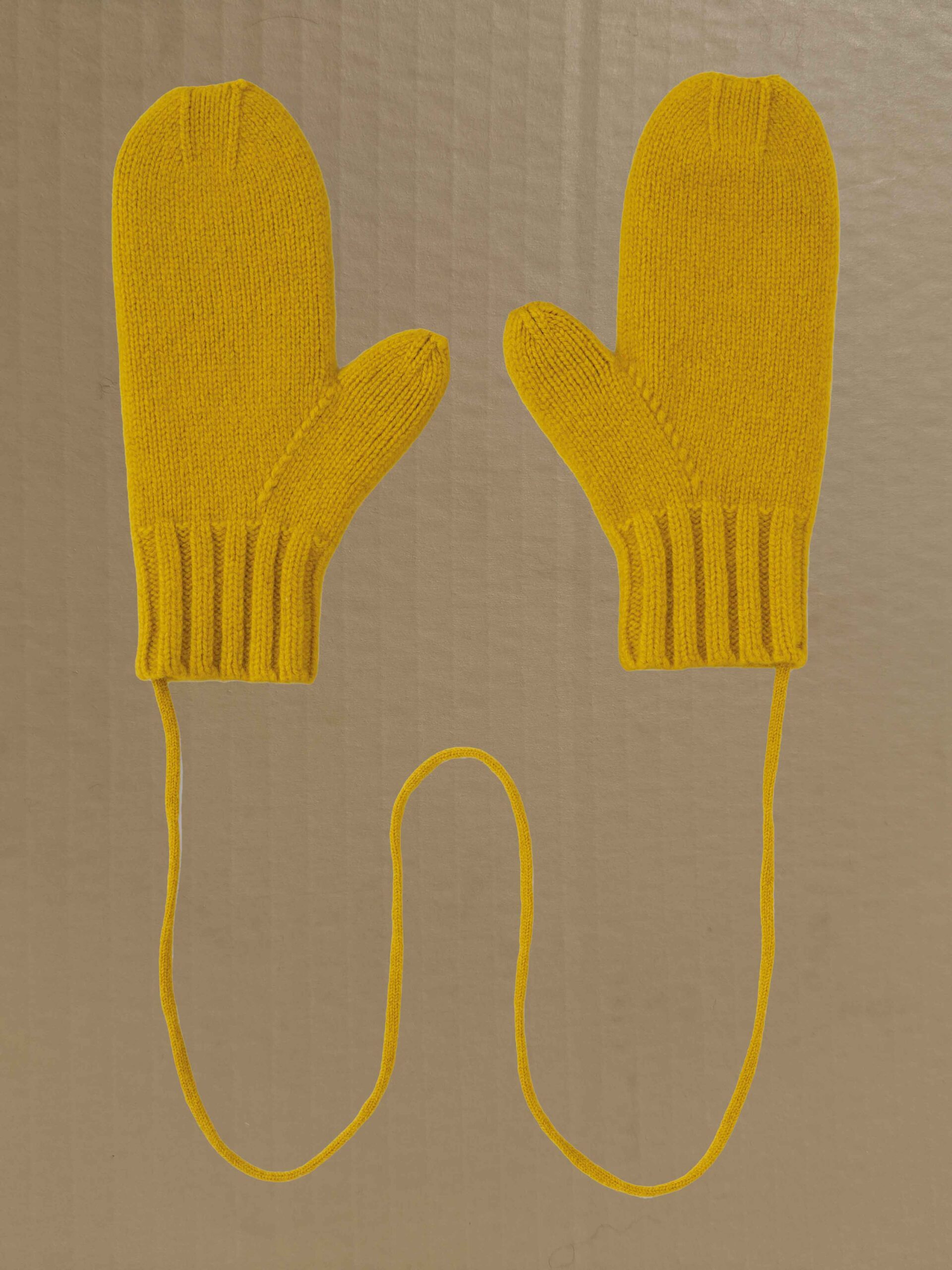 Felted plain mittens on string tumeric Scottish spun lambswool knitted Leicestershire England product